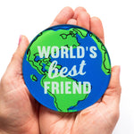 The words 'World's Best Friend' is printed on top of a world map on a coaster to make a useful gift for a friend